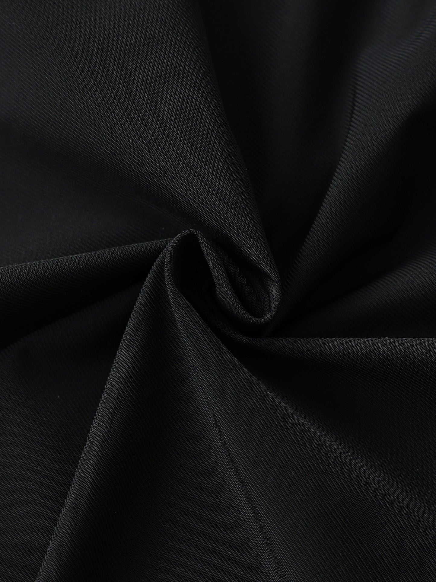 Close-up of black men's side-stripe performance shorts fabric made of nylon and spandex blend