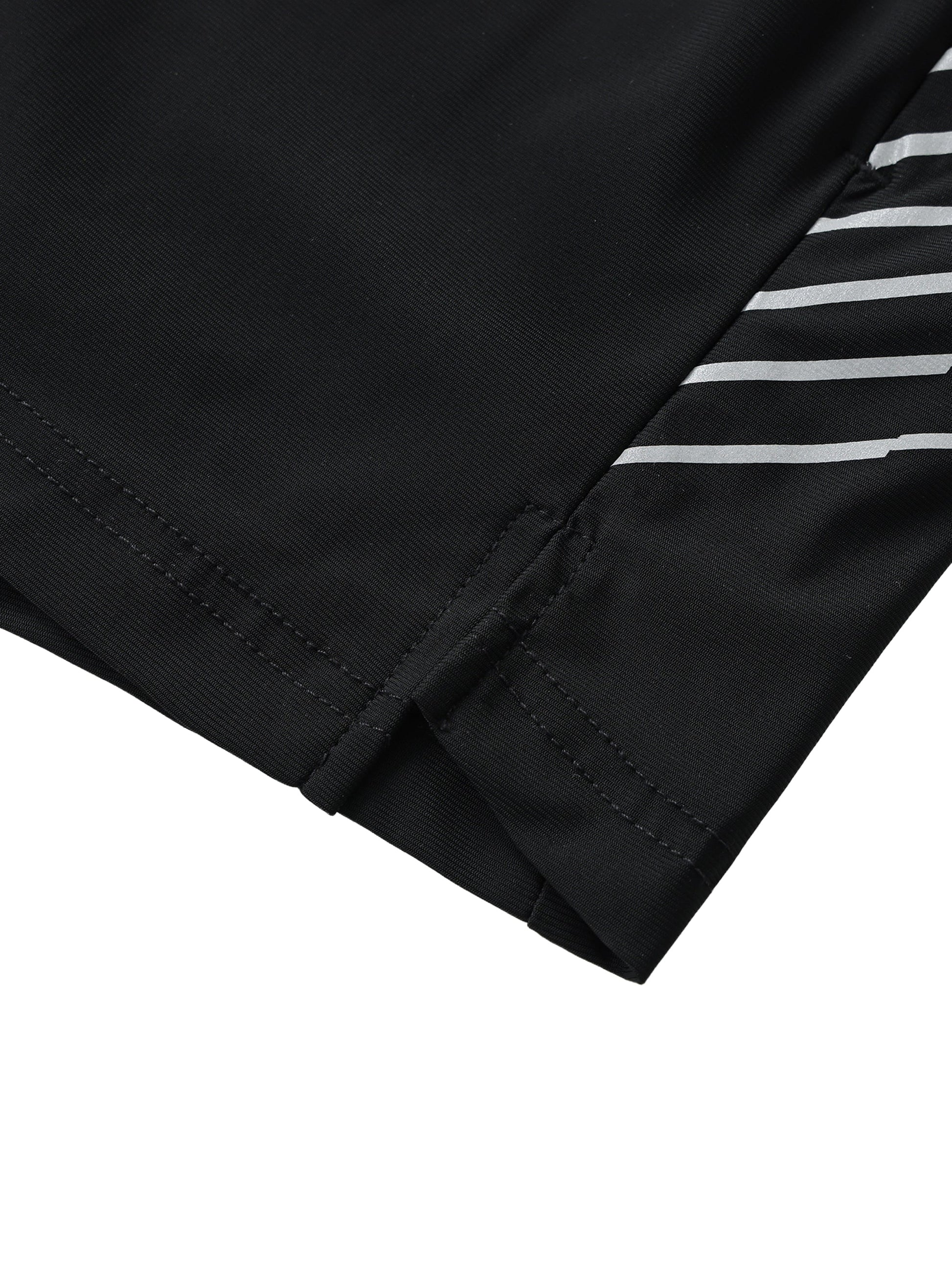 Close-up of men's side-stripe performance shorts hem with black fabric and white stripes